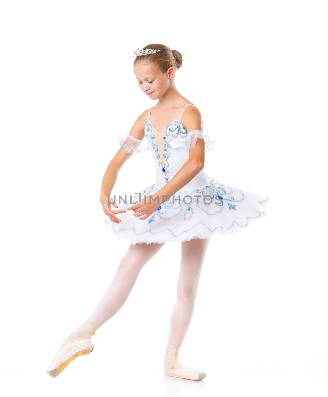 Beautiful young ballerina in classical tutu on a white background