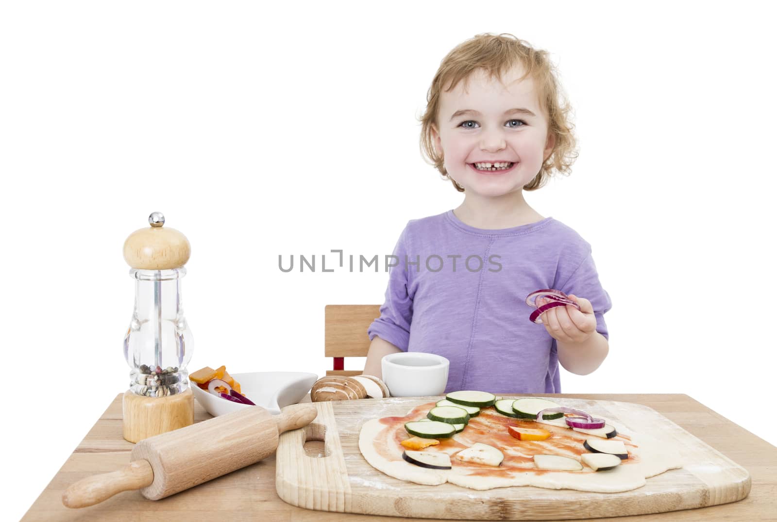 cute child making fresh pizza . studio shot isolated on white background