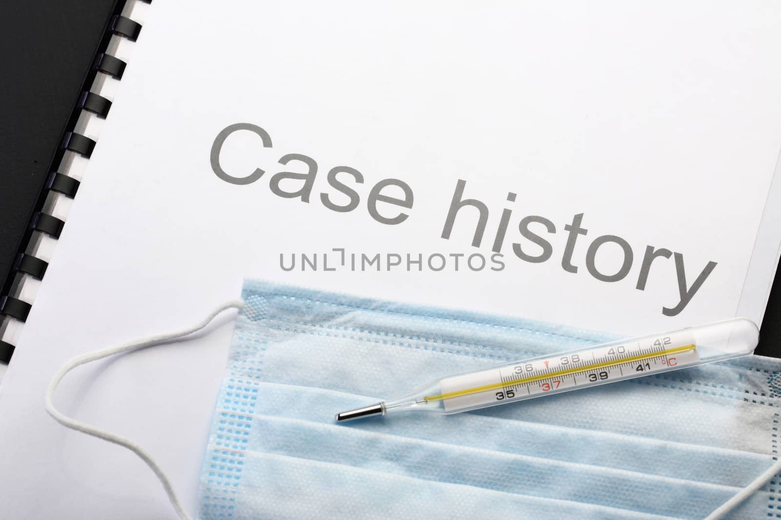 Case history, mask and thermometer on black