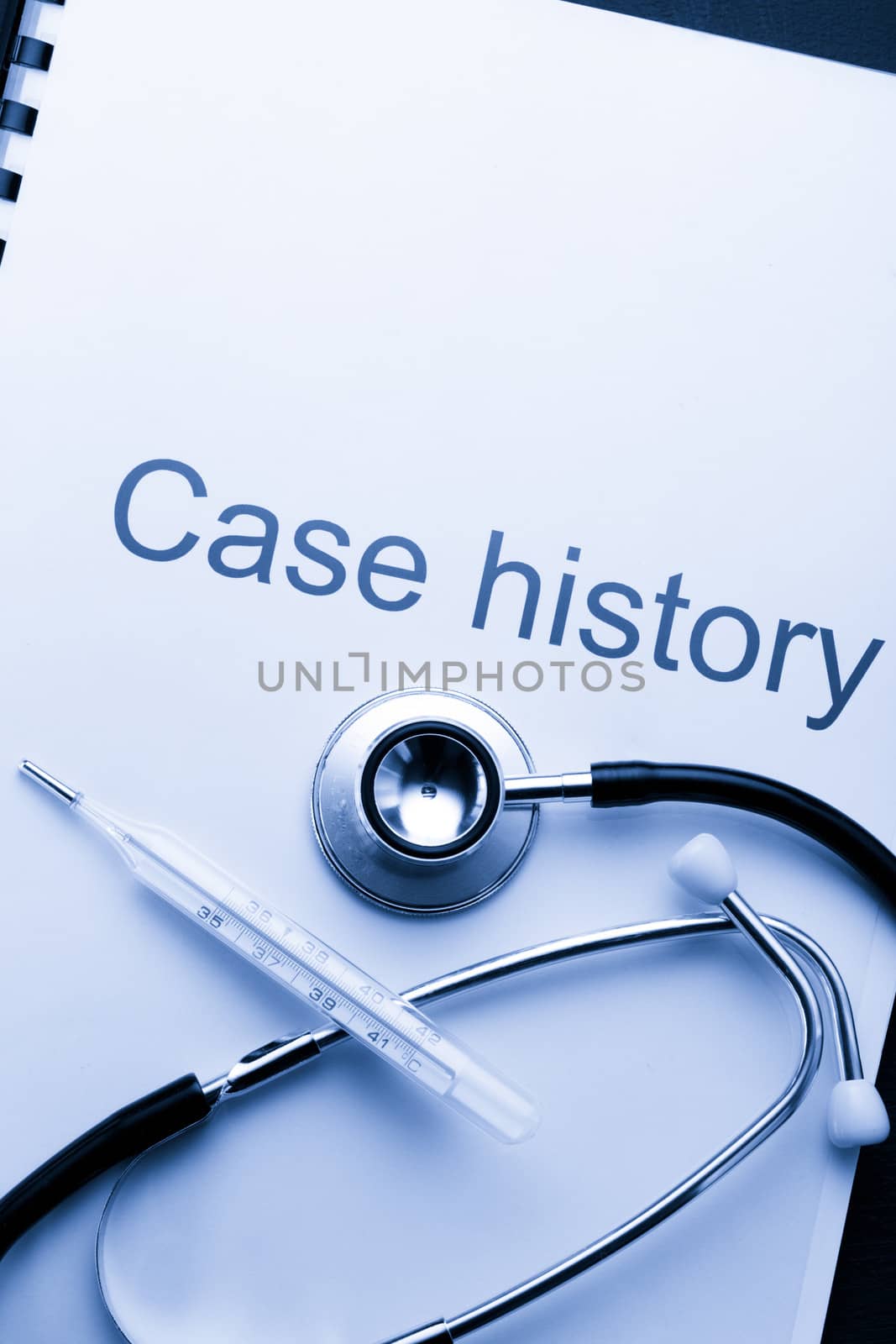 Case history, stethoscope and thermometer on black by Garsya