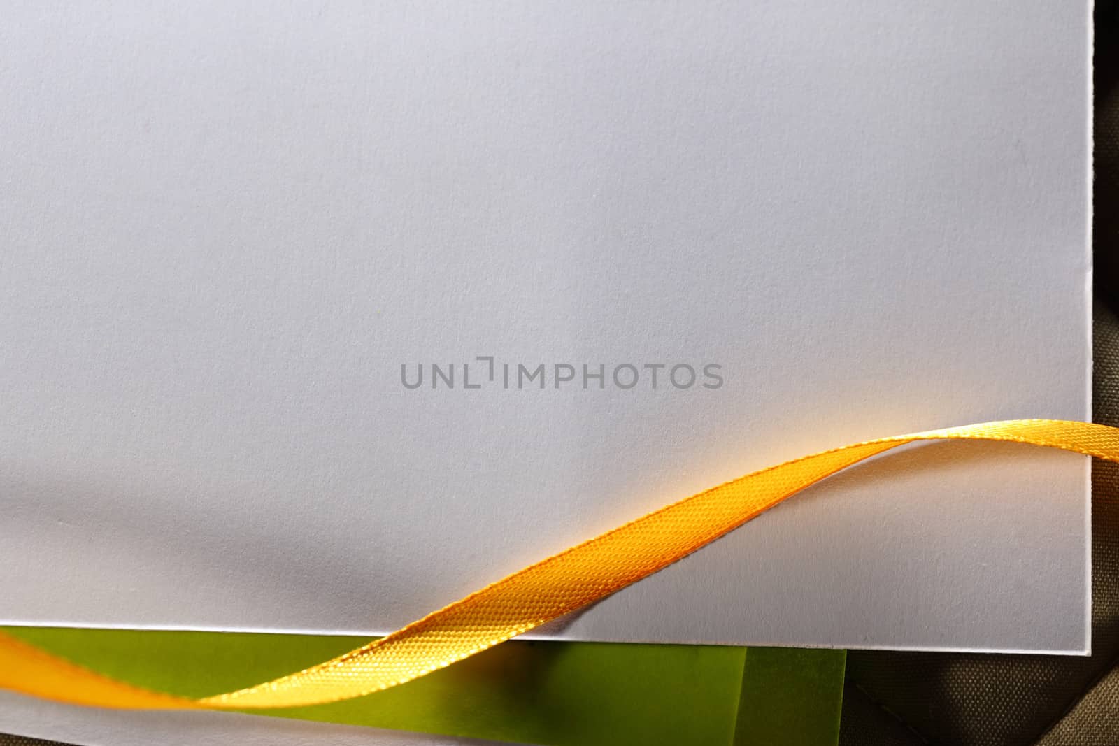 Blank greeting card with ribbons on checked background