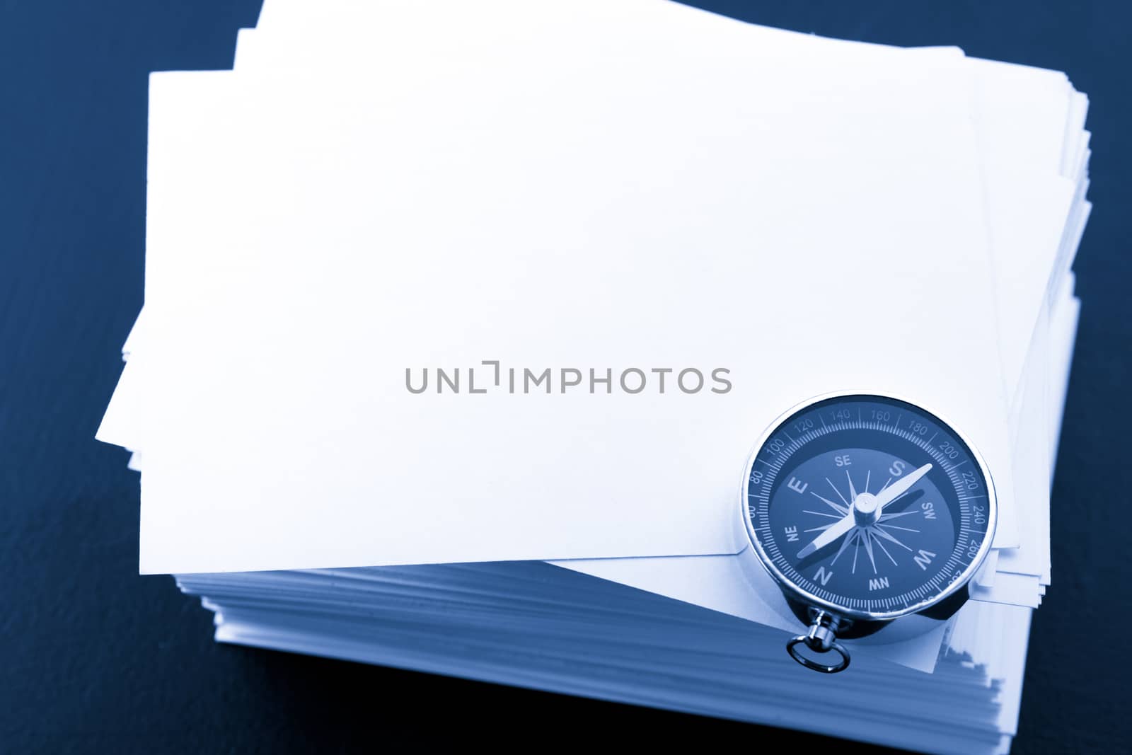 Stack of white cards and compass by Garsya