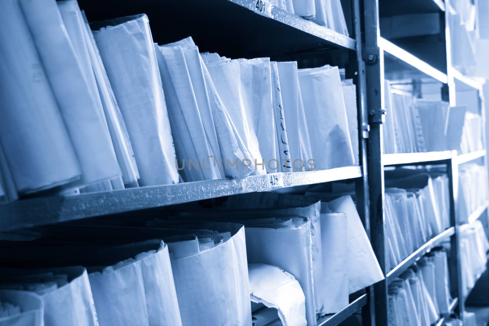 Paper documents stacked in archive