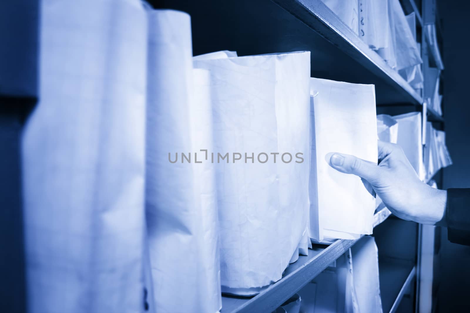 Paper documents stacked in archive