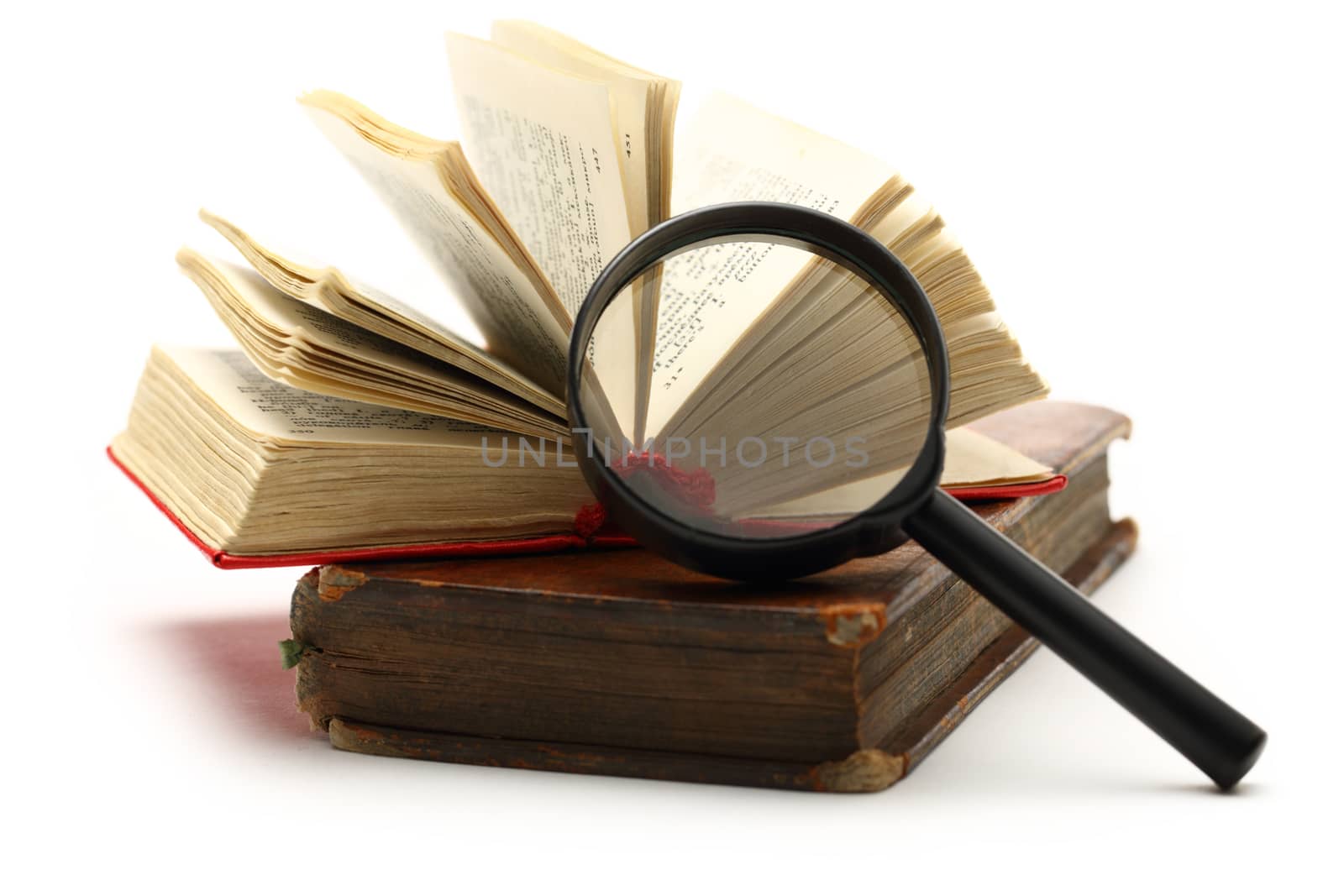 Magnifying glass and old books