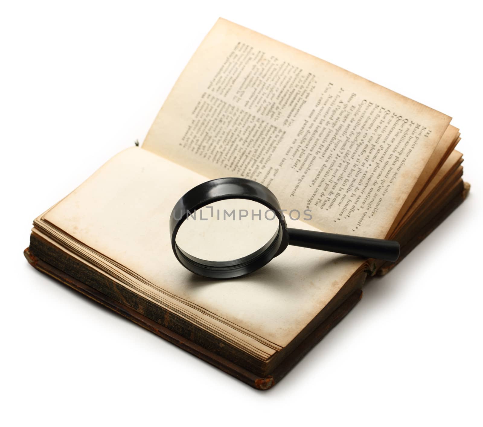 Magnifying glass and old book on the white background