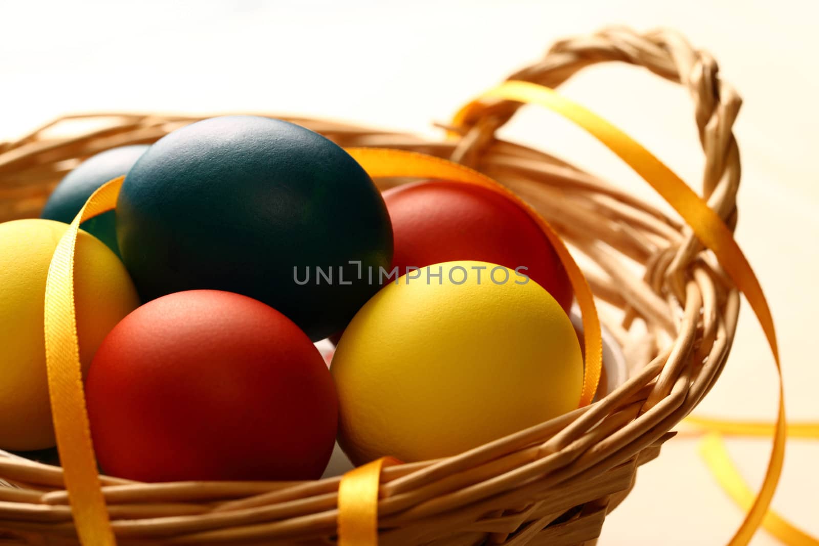 Easter eggs with yellow ribbon in basket