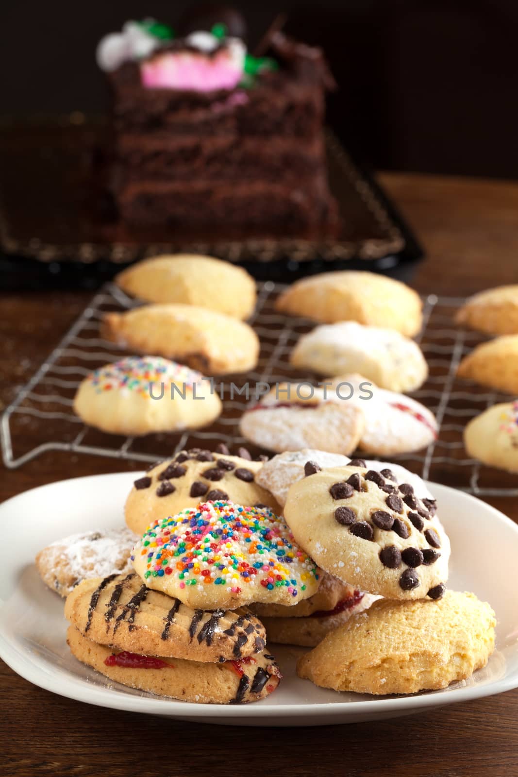 Italian cookies on a plate and some cooling on a rack in the background. Shallow depth of field.