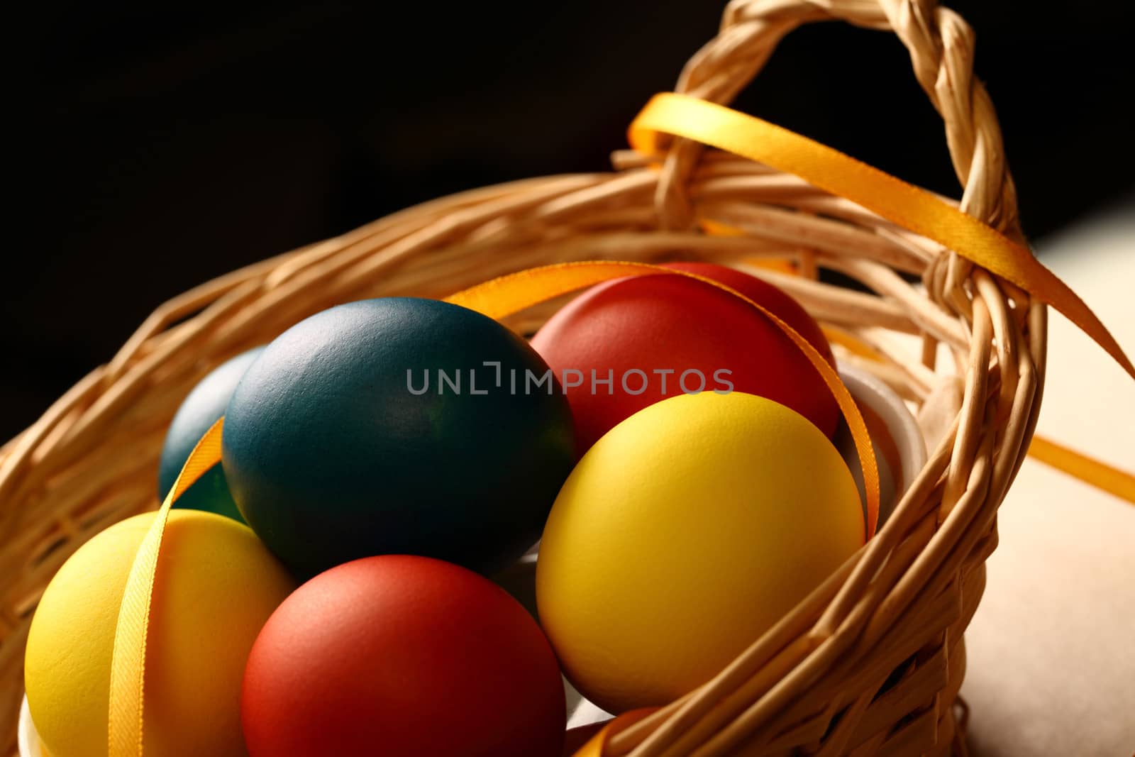 Easter eggs with yellow ribbon in basket