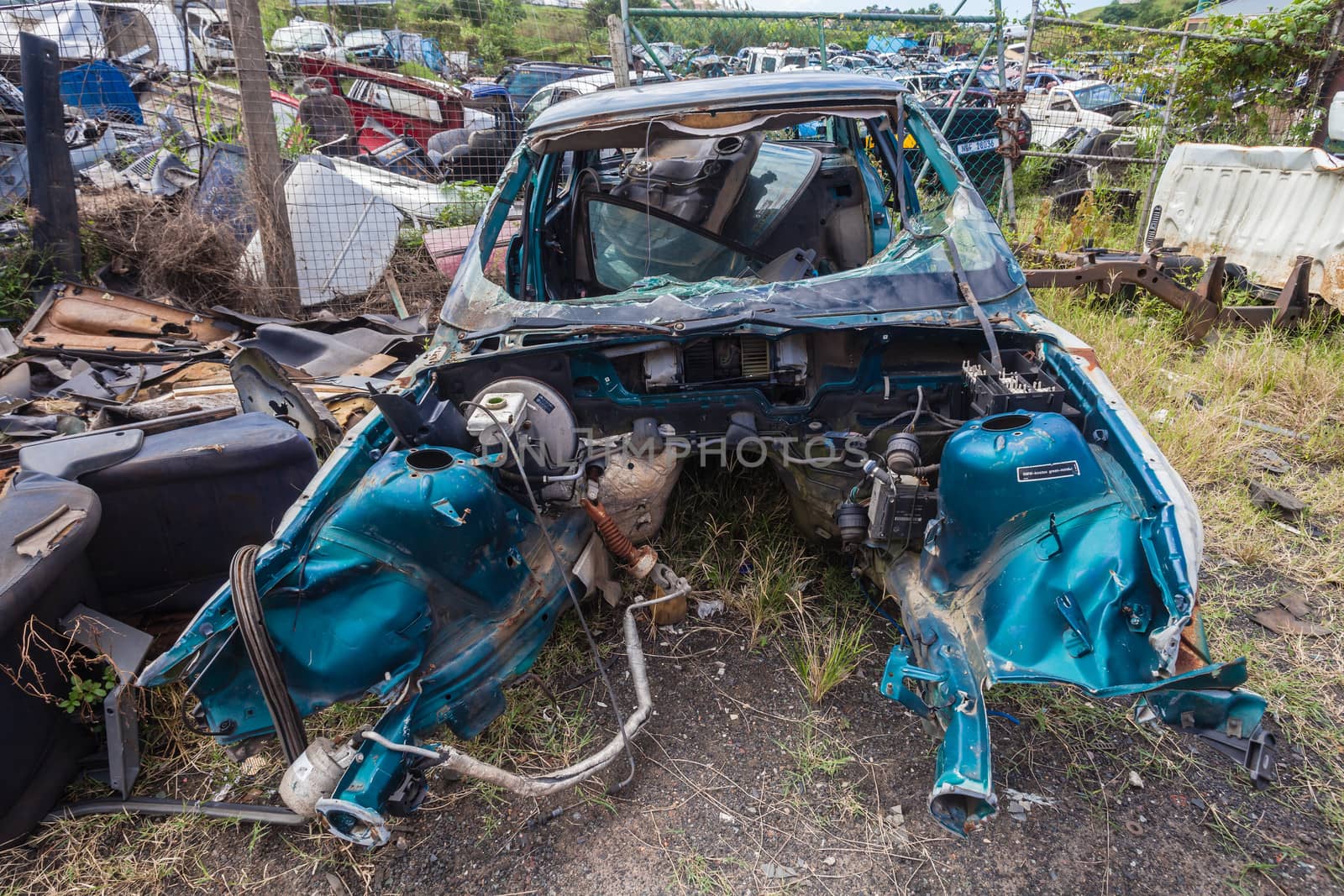 Destroyed vehicle unrecognizable after car crash stripped.