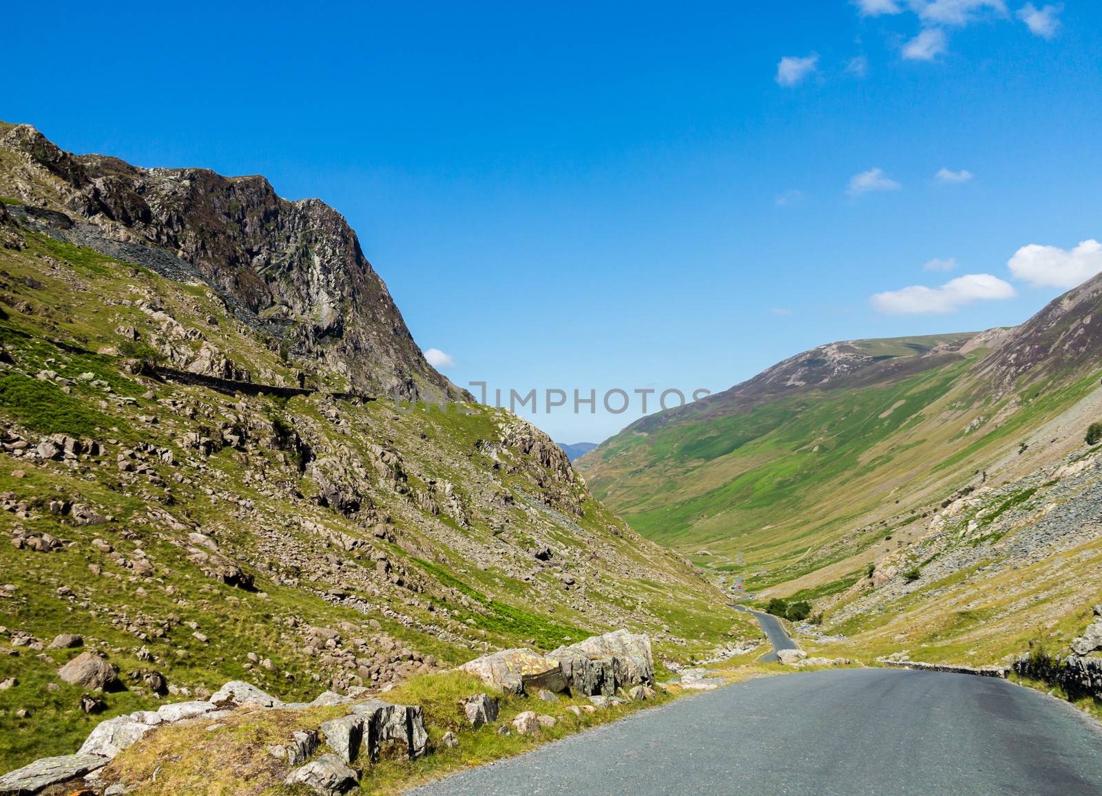 Narrow road leads down from Honister Pass in the English Lakes or Lakeland Lake District in Cumbria