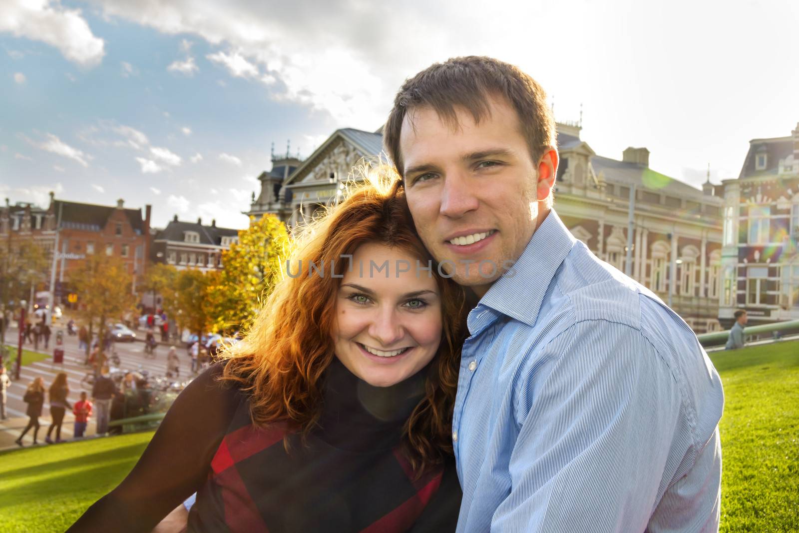 Outdoor happy couple in love posing in Museum Plein, autumn Amst by Tetyana