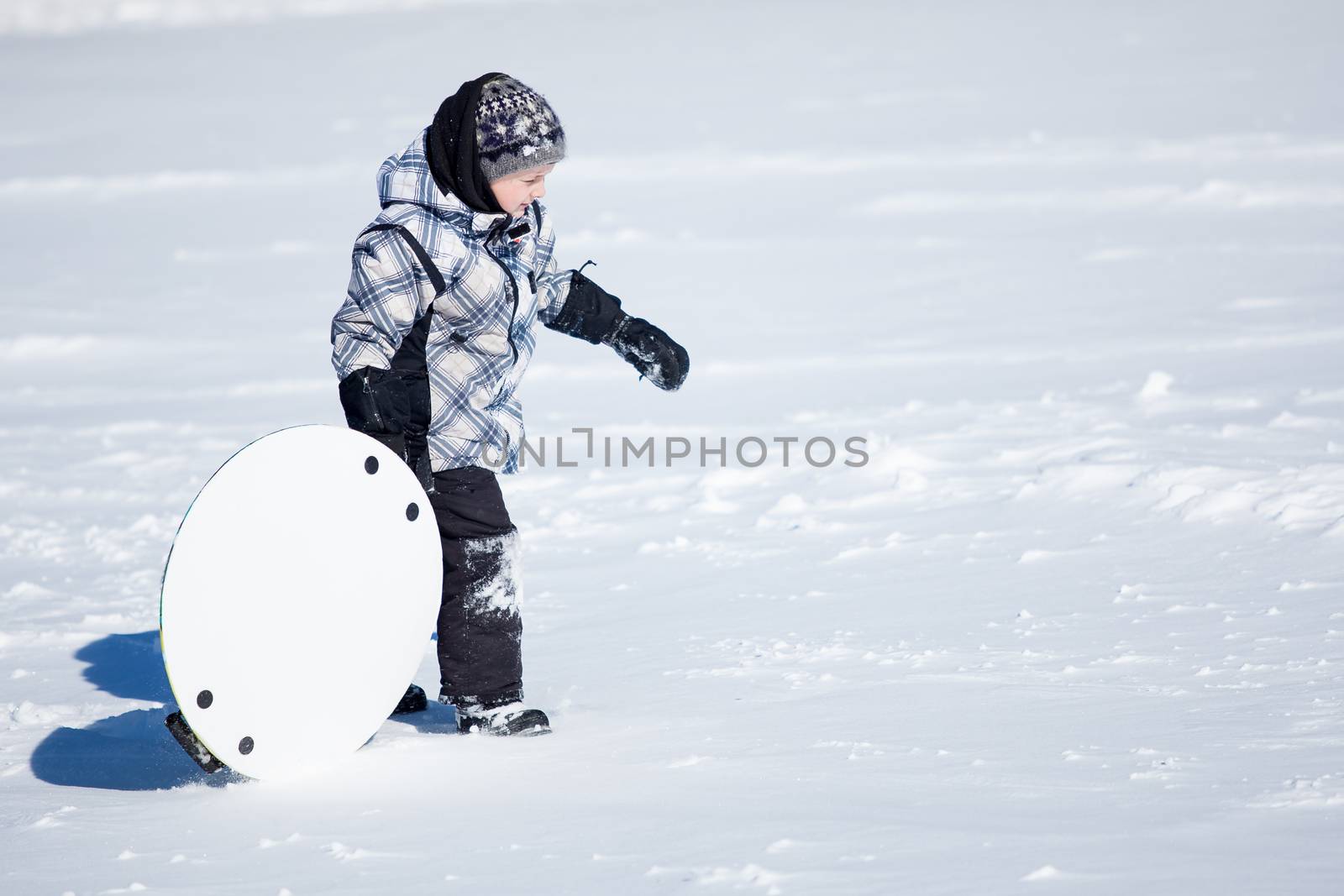Boy walking in the snow by Talanis