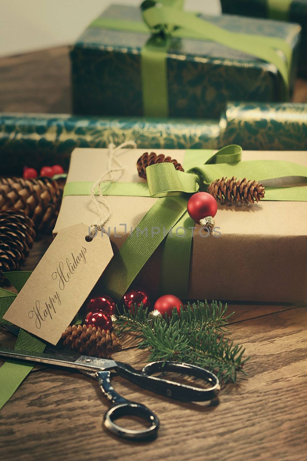 Gifts with tag for the holidays on wood table by Sandralise