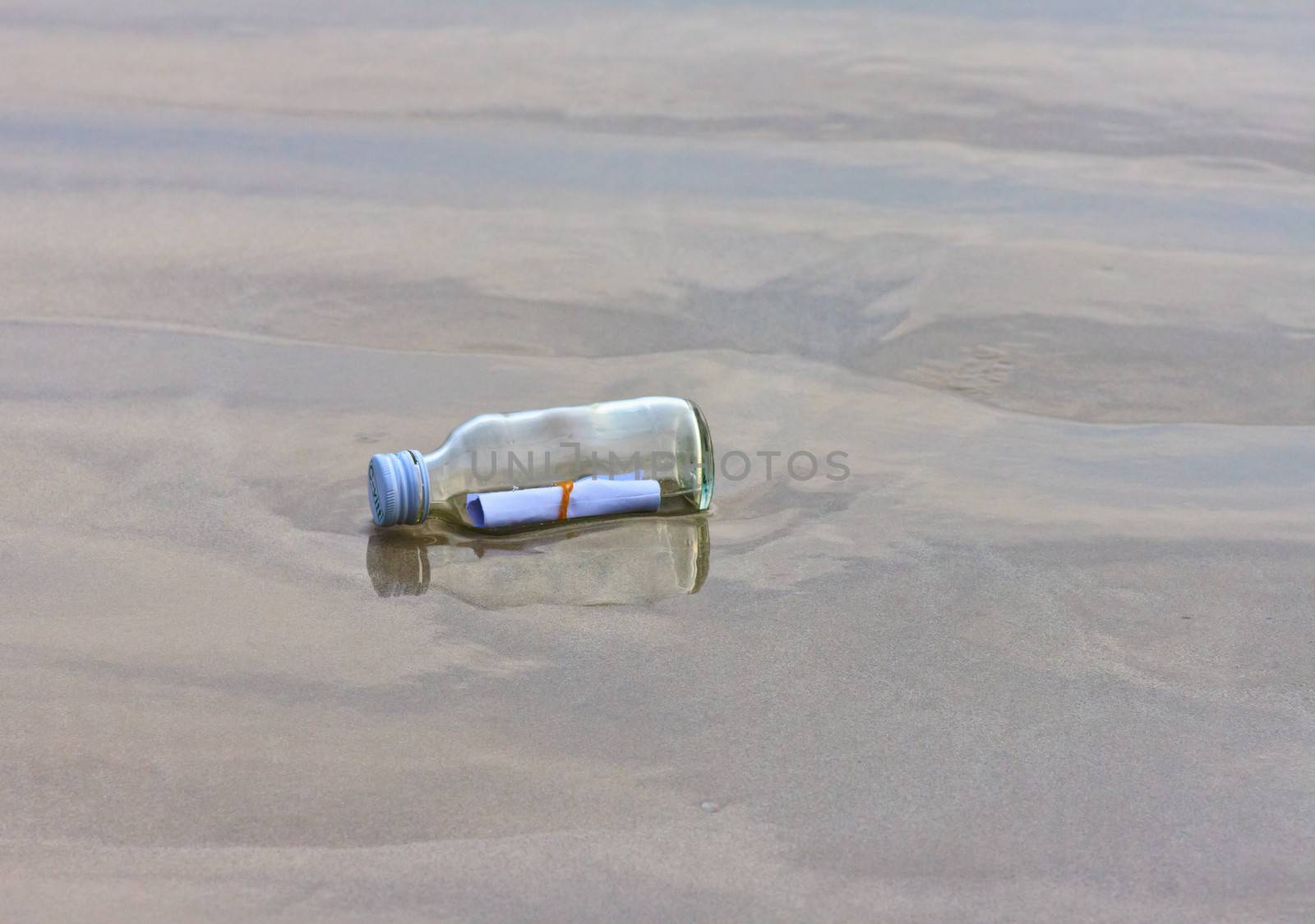  glass bottle on the beach  by nikky1972