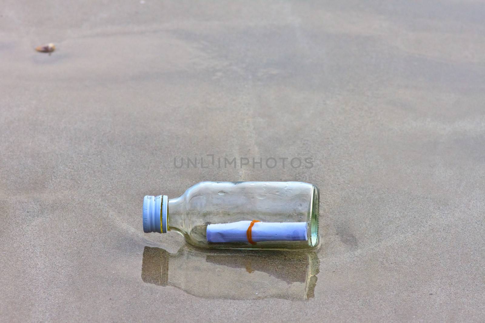  glass bottle on the beach  by nikky1972