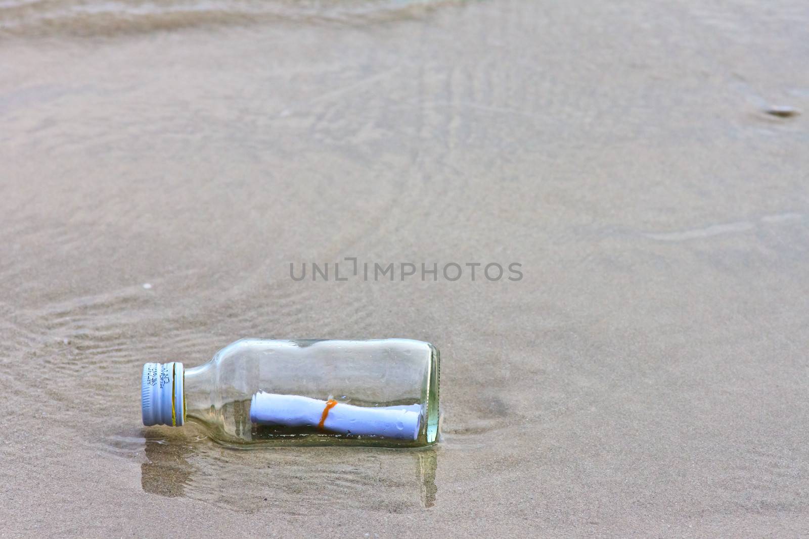  glass bottle on the beach  by nikky1972