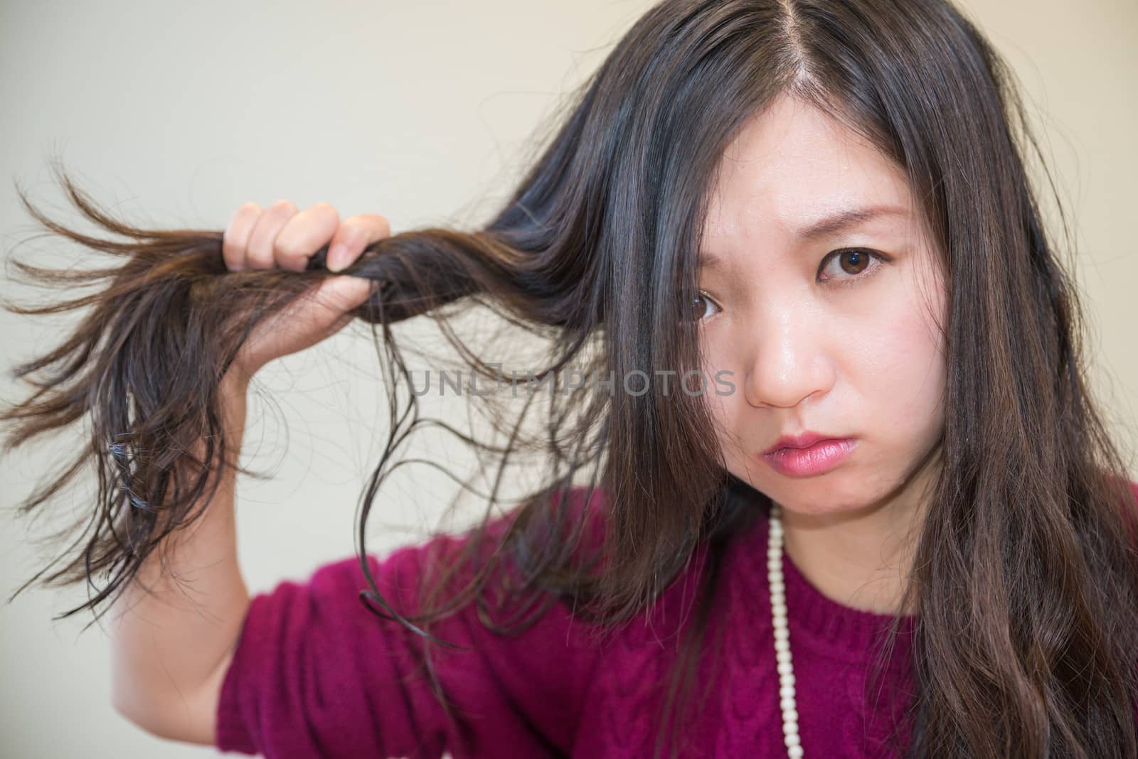 Young woman pulling her hair looking frustrated