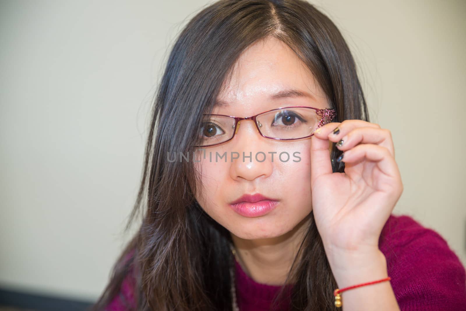 Close portrait of young woman with glasses