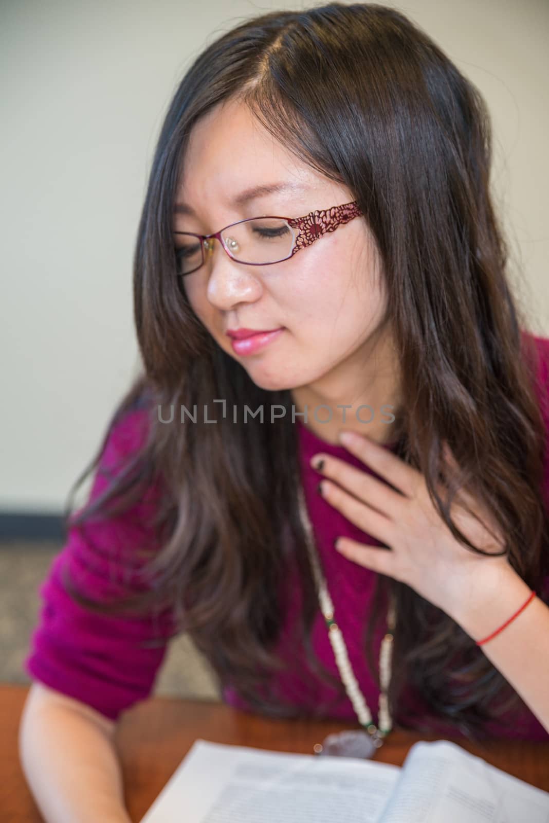 Portrait of young woman with glasses and book