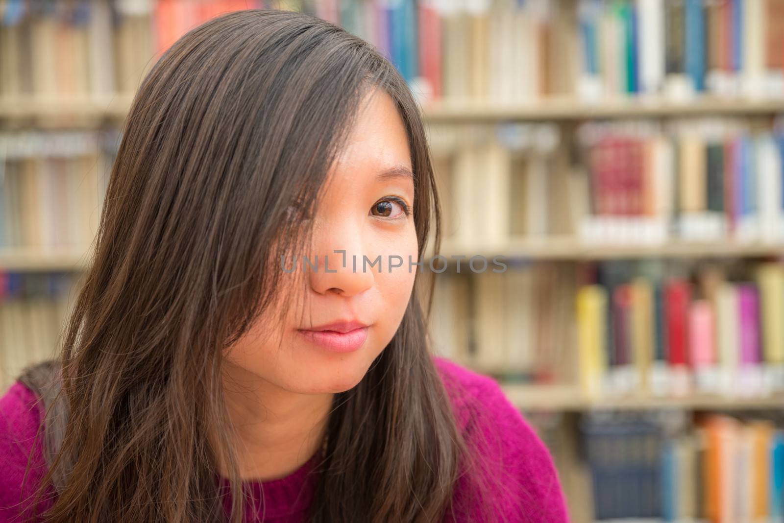 Close portrait of young woman in library