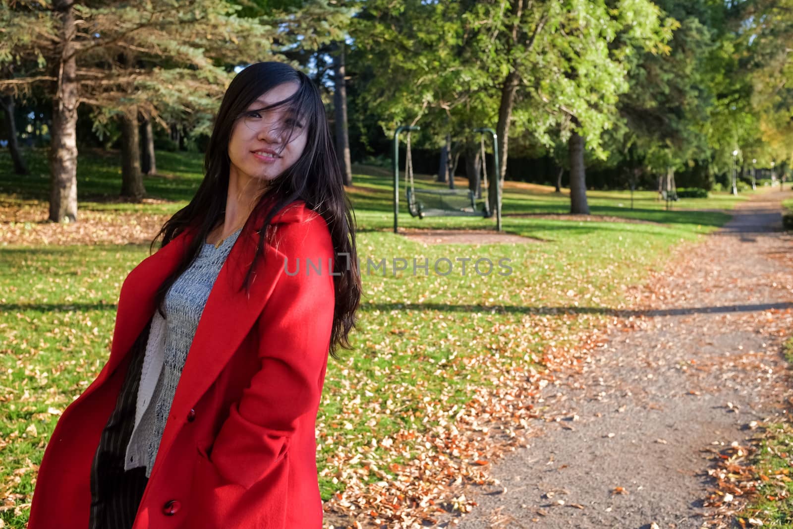 Woman at the end of a road swinging her hair