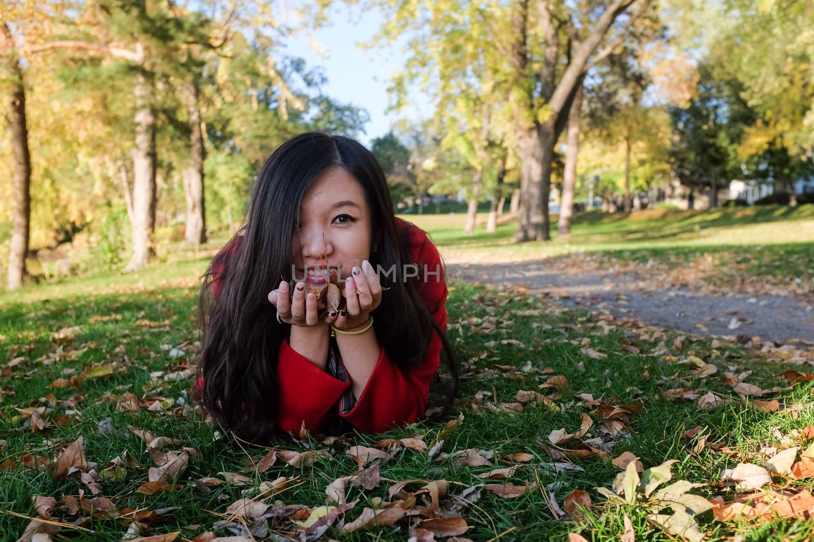 Woman laying on grass looking happy