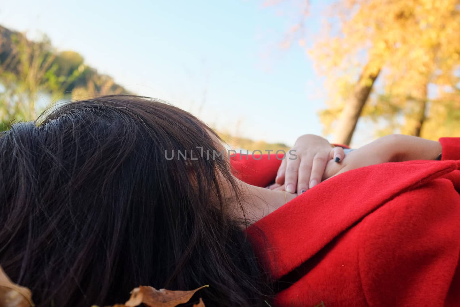Young woman laying on grass with spreaded hair