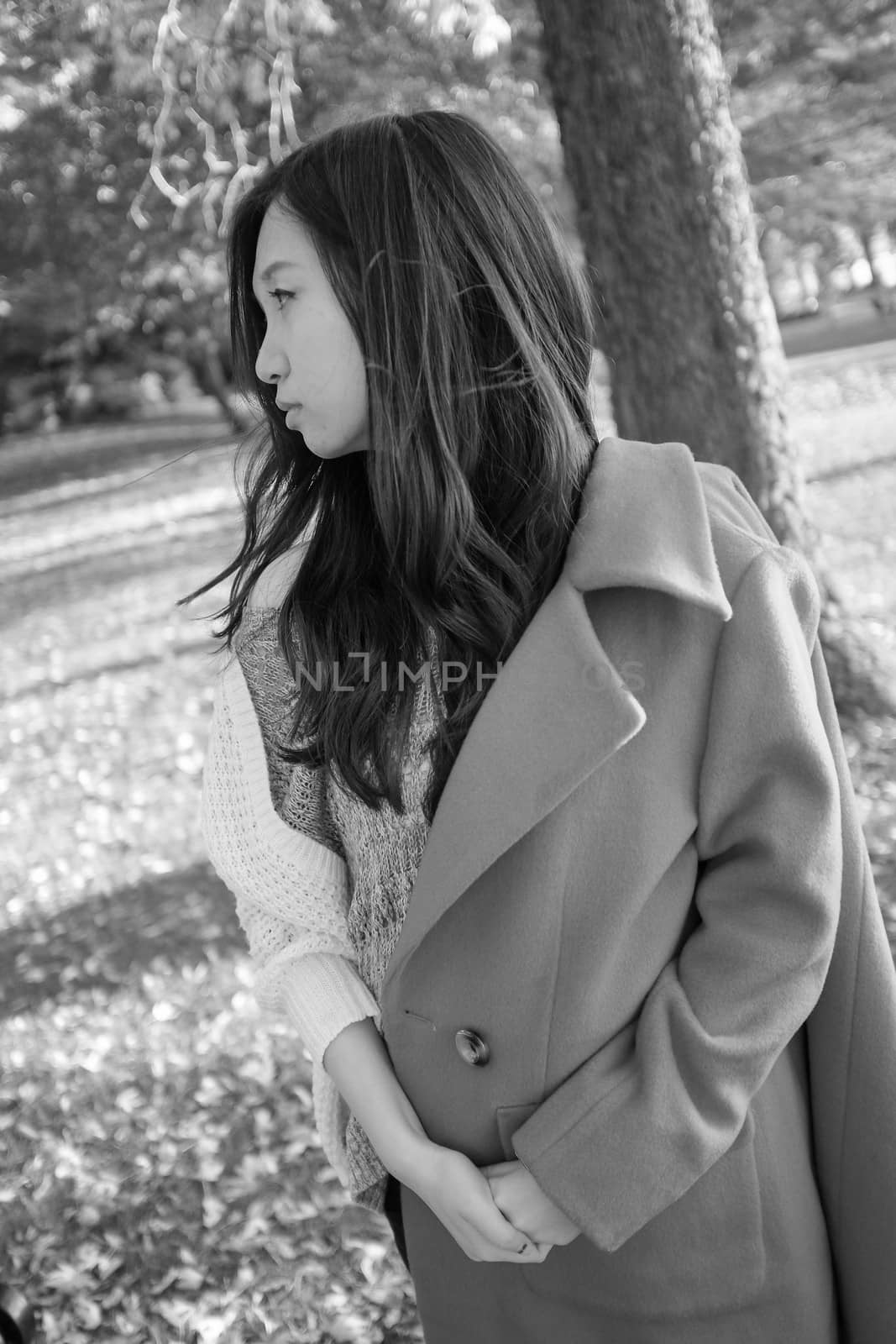 Young woman with coat half on looking sad