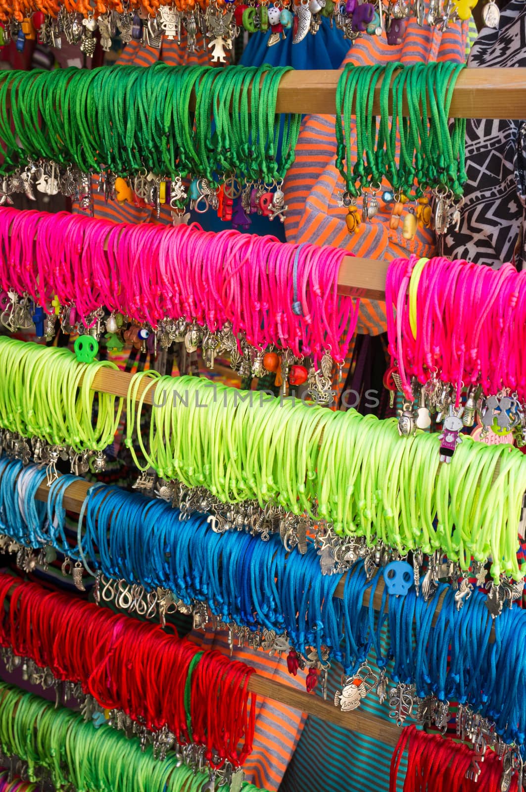 Many colorful bracelets displayed on a street market stall