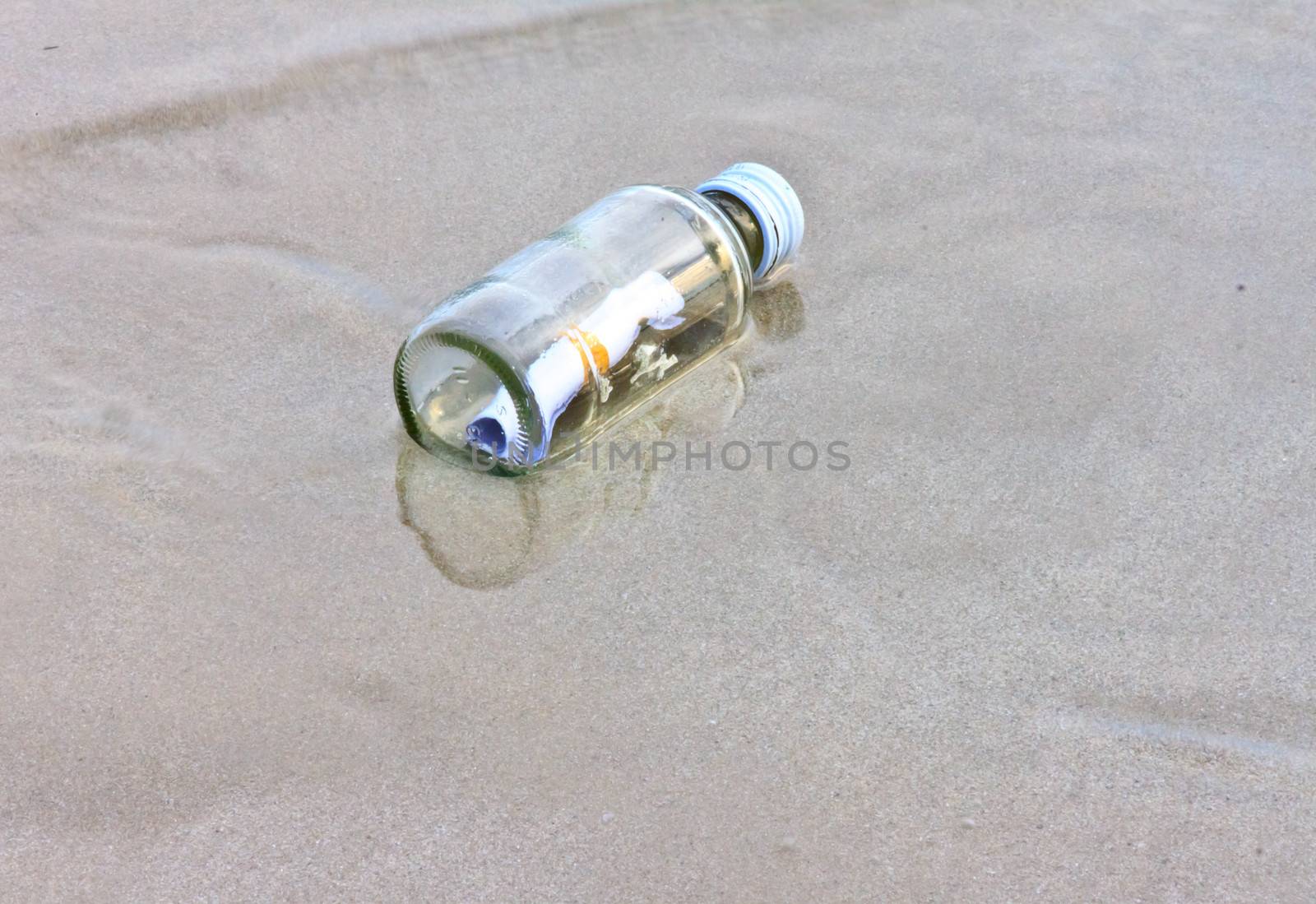  glass bottle on the beach  by nikky1972