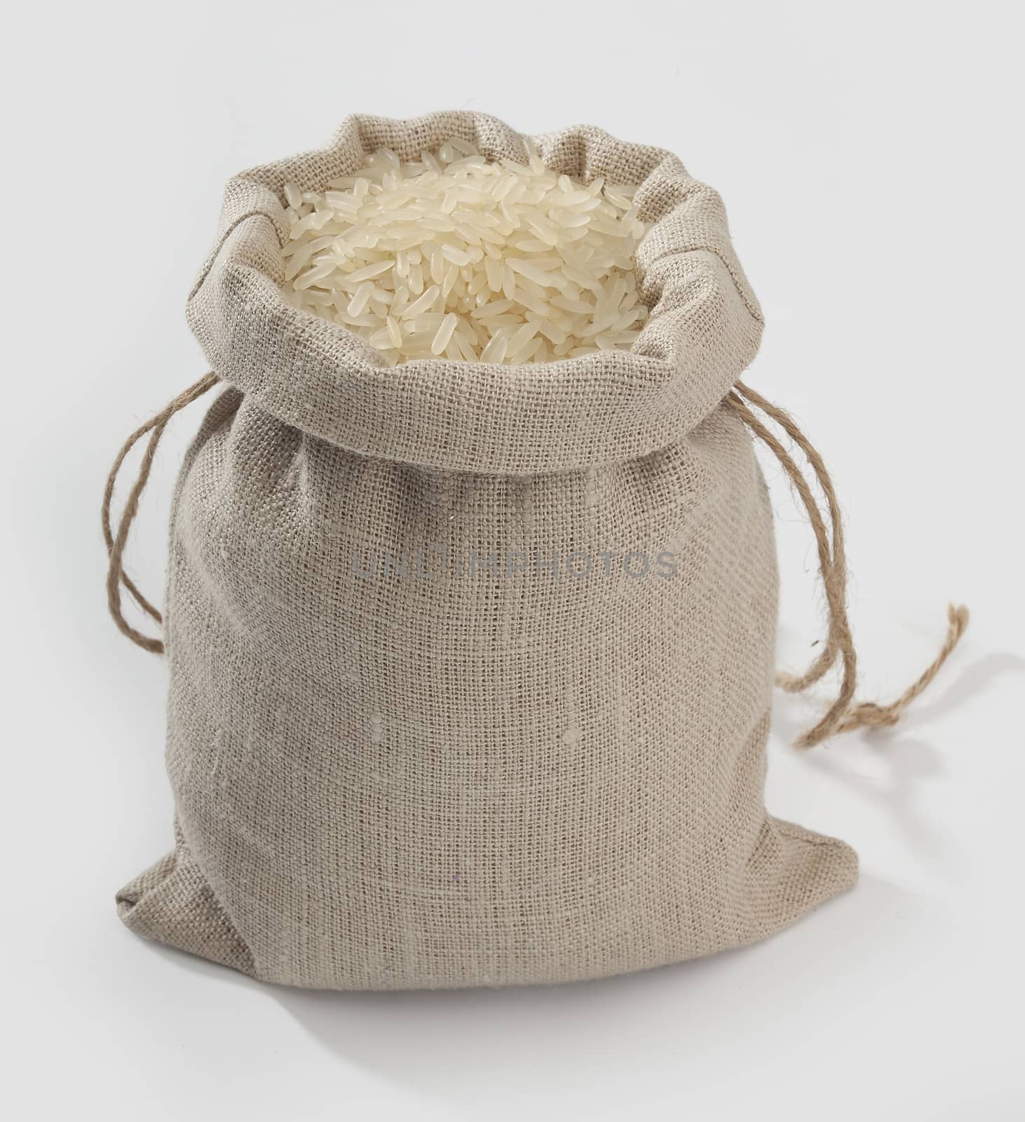 Sack with rice on the grey background