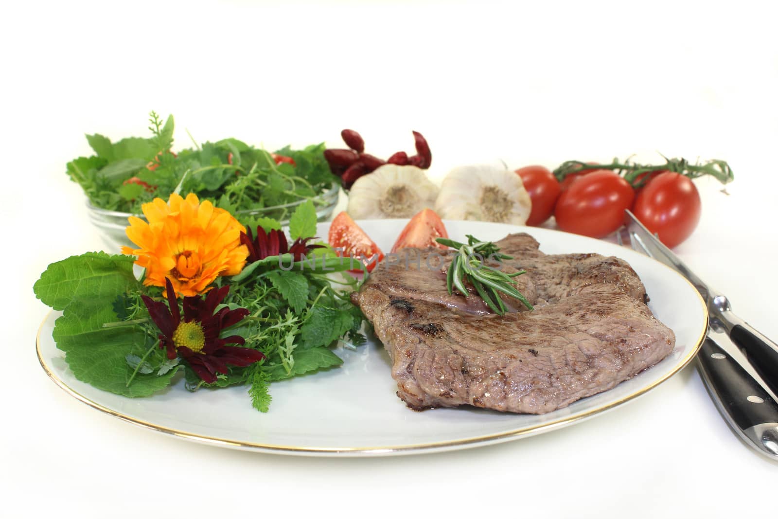 a roasted ribeye steak with wild herb salad