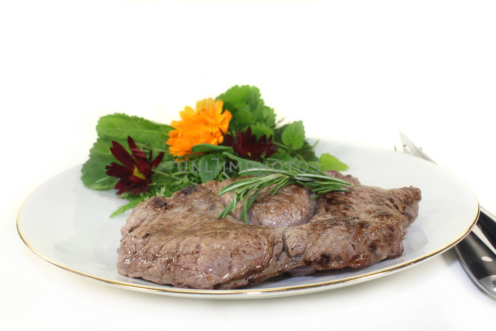 a roasted ribeye steak with wild herb salad