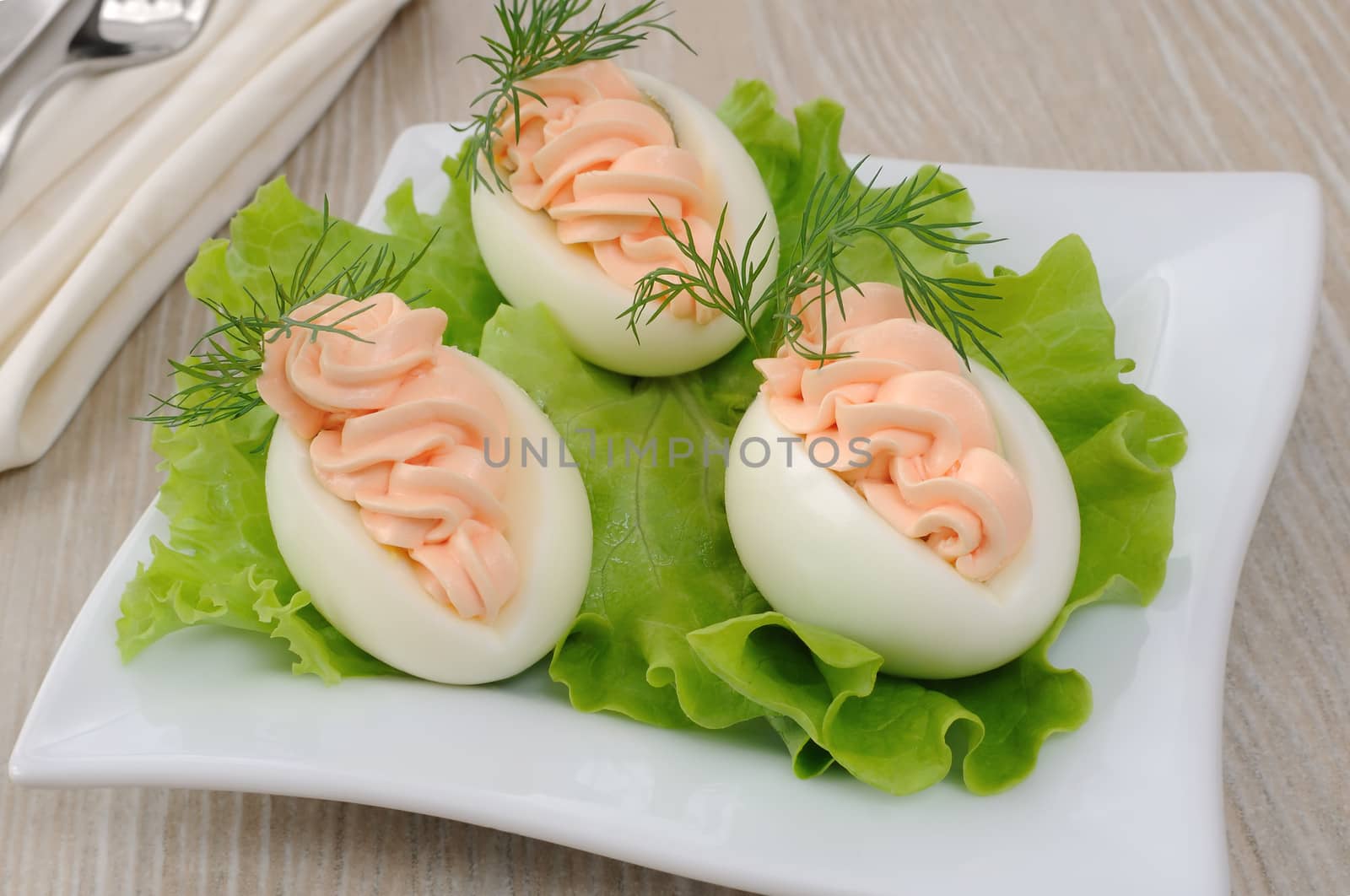 Eggs stuffed with salmon pate in lettuce leaves