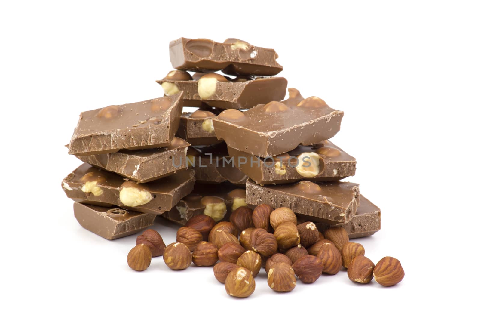 chocolate and hazelnuts on white background