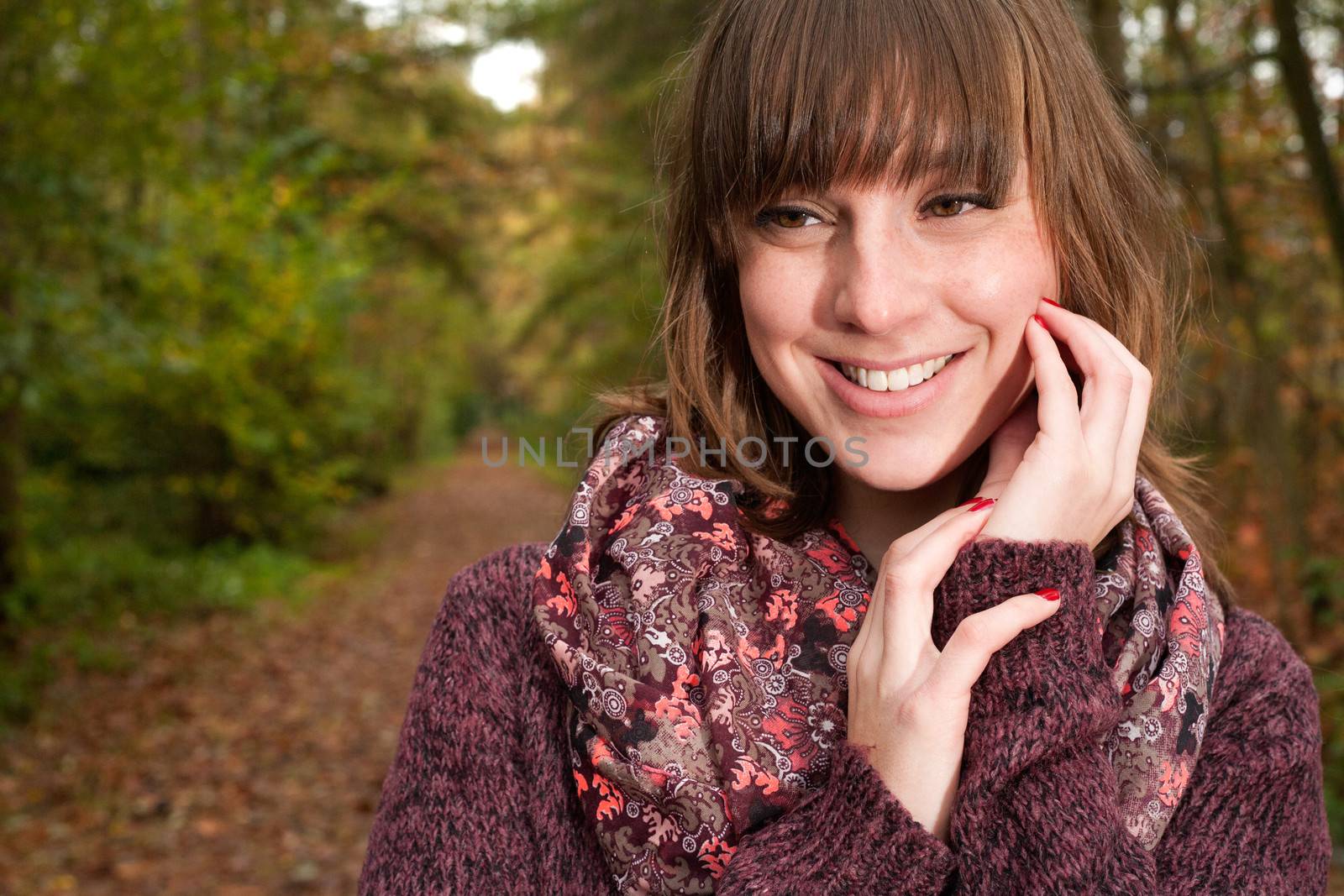 Young woman in the autumn at a cold november day