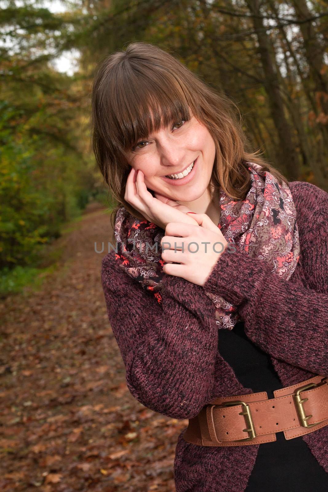 Young woman in the autumn at a cold november day