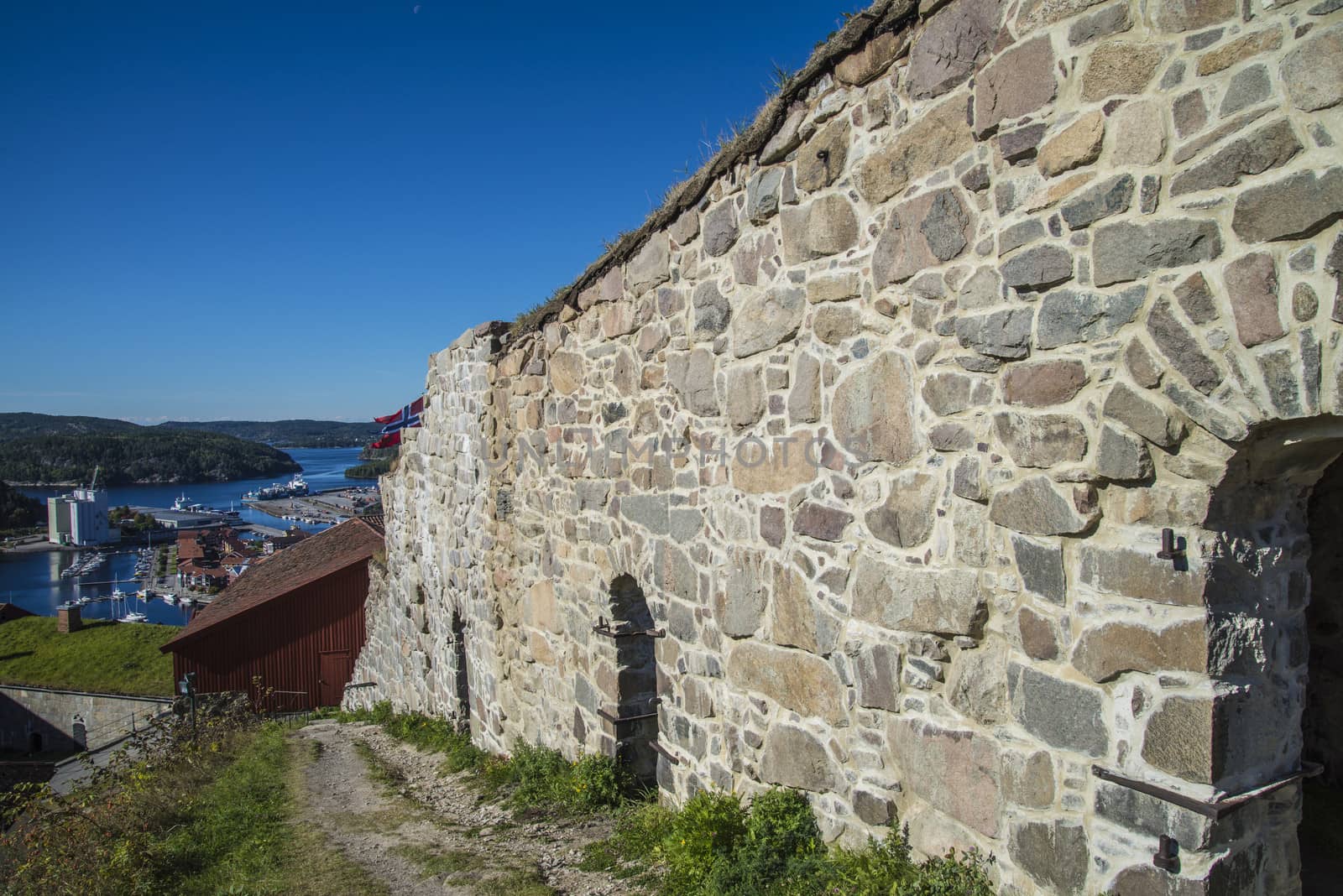 The image is shot in September 2013 at Fredriksten Fortress in Halden, Noway and shows the Large powderhouses and Northern curtain wall that protects the Citadel to the west and connects Queen's bastion with Prince Chritians bastion, the curtain wall was completed in 1668
