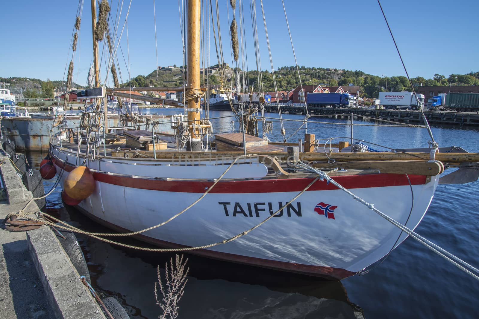 Old dignified sailboat built of wood. Taifun is moored to the dock at the port of Halden, Norway. Photo is shot one day in September 2013.