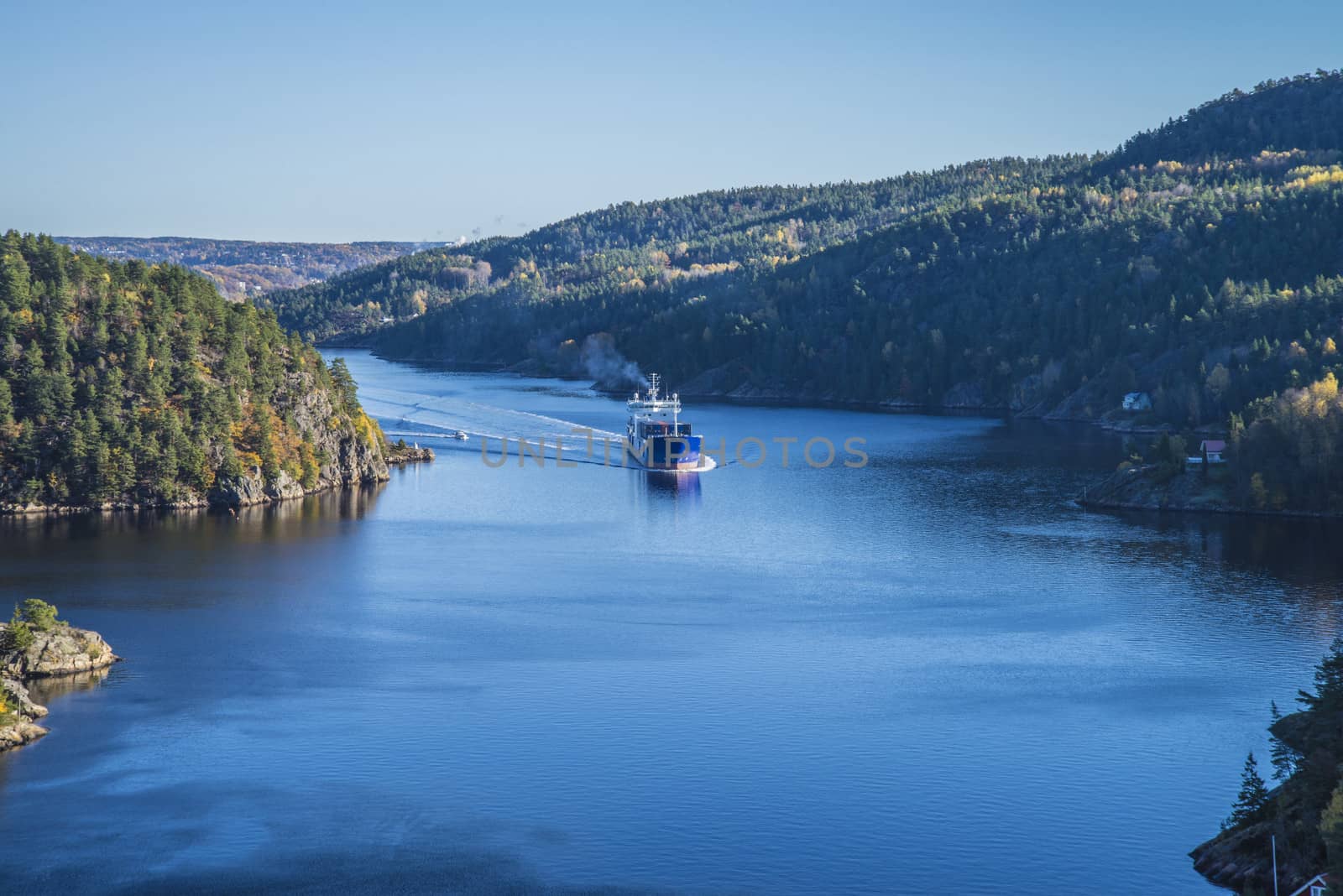 MV Lysbris sailing through Ringdalsfjord from Halden, Norway harbor and out to the open ocean. Vessel's Details: Ship Type: Cargo / container ship, built 1999, Length x Breadth: 129 m X 18 m, Gross Tonnage: 7409, DWT (deadweight tons): 7500 h, Flag: Norway (NO). Photo is shot from Svinesund bridge 18 October 2013.