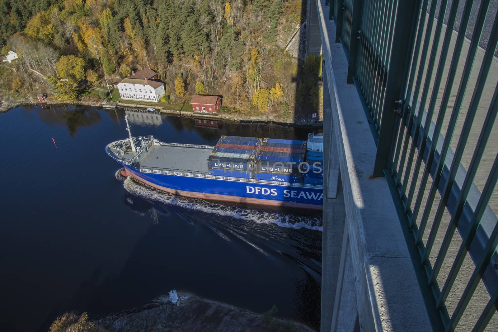 MV Lysbris sailing through Ringdalsfjord from Halden, Norway harbor and out to the open ocean. Vessel's Details: Ship Type: Cargo / container ship, built 1999, Length x Breadth: 129 m X 18 m, Gross Tonnage: 7409, DWT (deadweight tons): 7500 h, Flag: Norway (NO). Photo is shot from Svinesund bridge 18 October 2013.