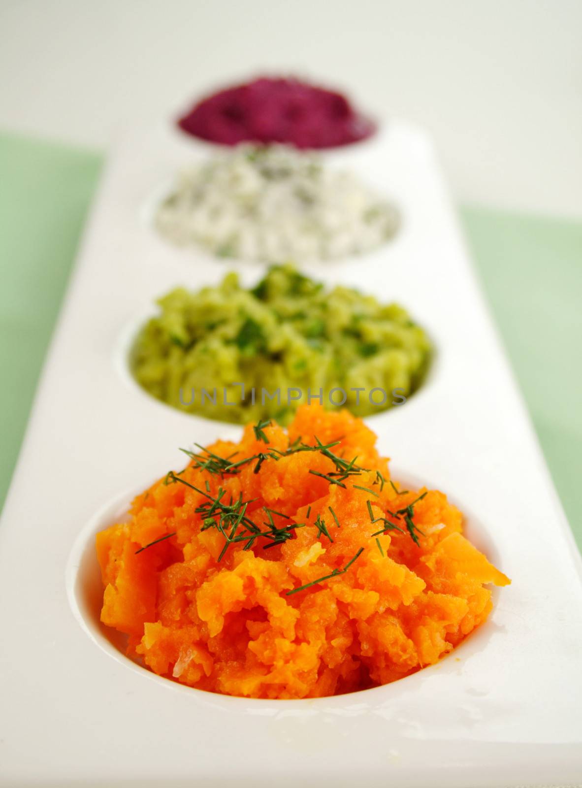 Assorted dips of beetroot, carrot, cottage cheese and herbs and pea and basil.