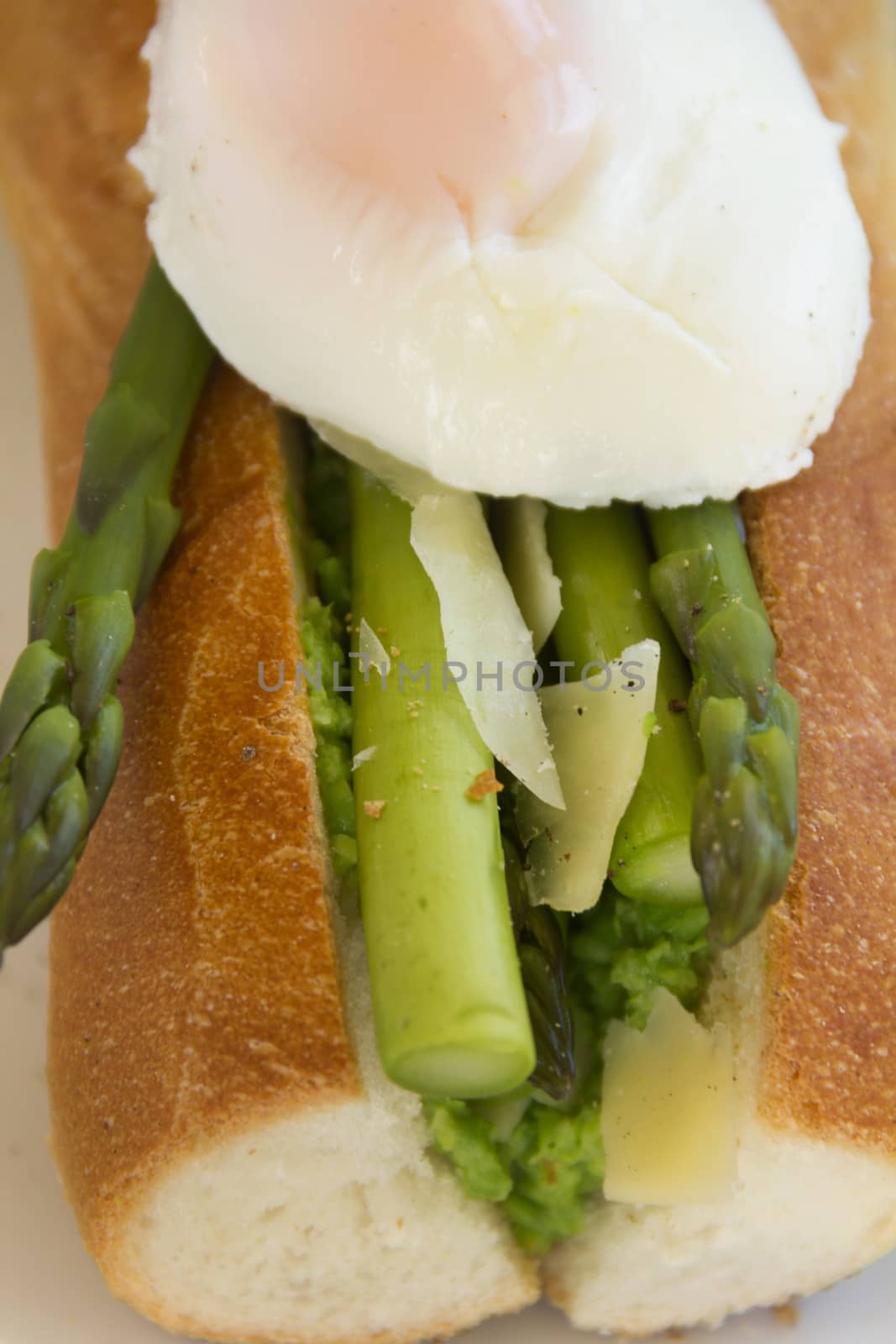 Delicious asparagus and mashed peas topped with a poached egg on a crispy baguette.