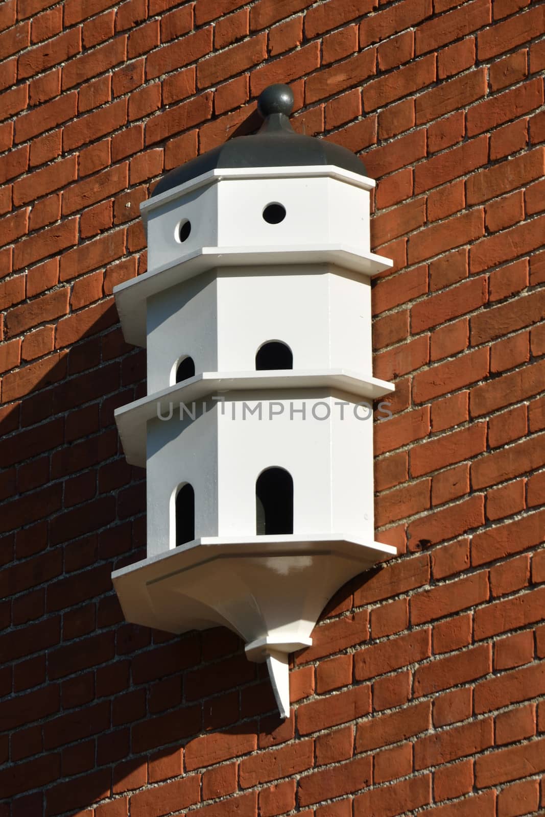 White Dovecote on red brick wall