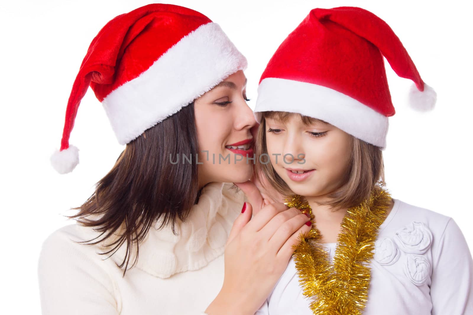 Mother and daughter sharing each other secrets on Christmas Eve over white