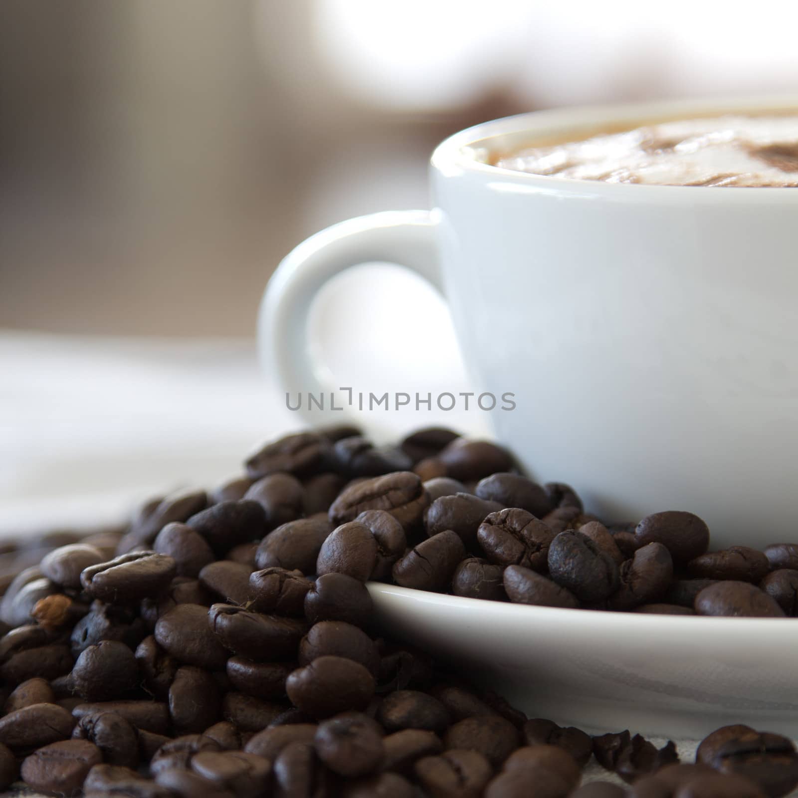 Coffee cup and beans on a white background.