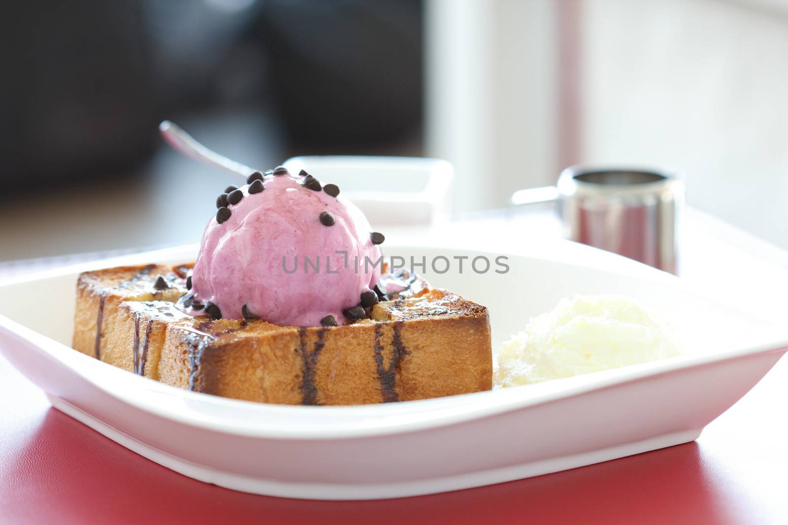 Strawberry ice cream topped with berries, chocolate on bread