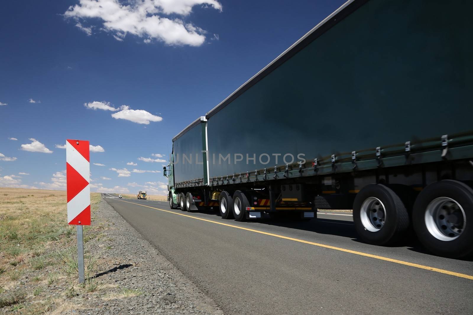 Large horse and trailer truck transporting cargo on the road