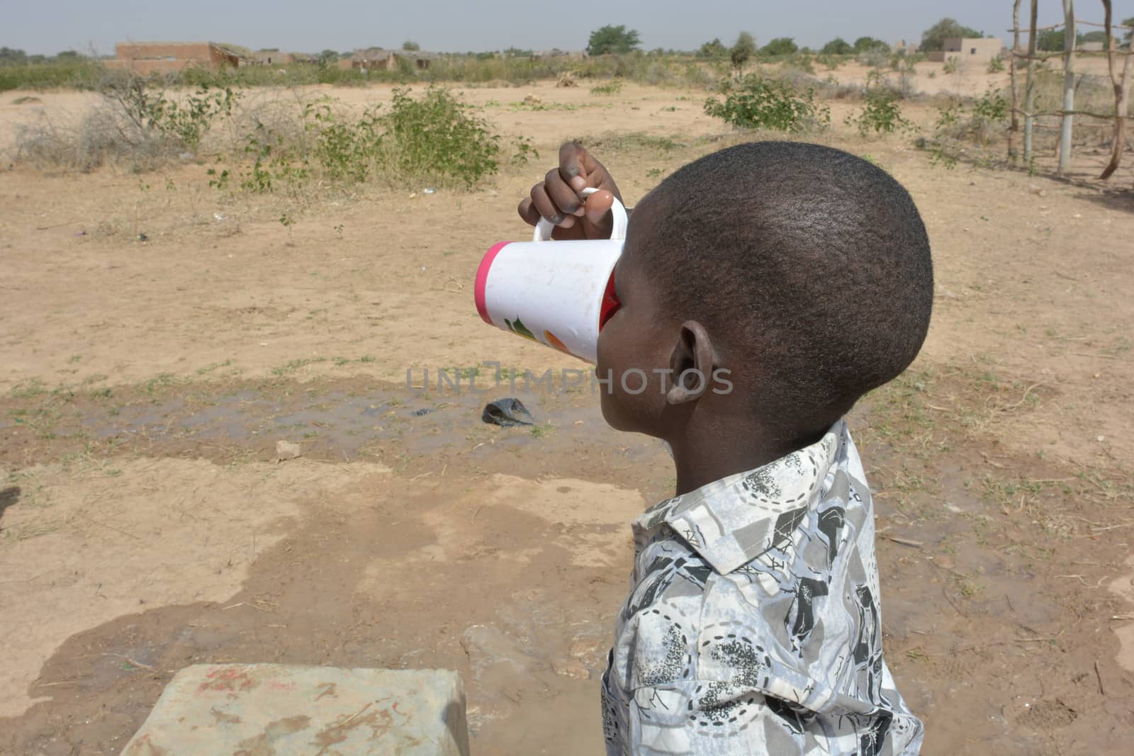 African child drinks water